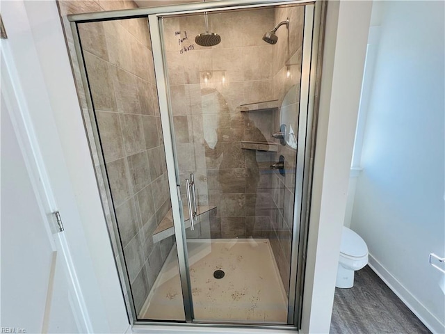 bathroom with walk in shower, wood-type flooring, and toilet