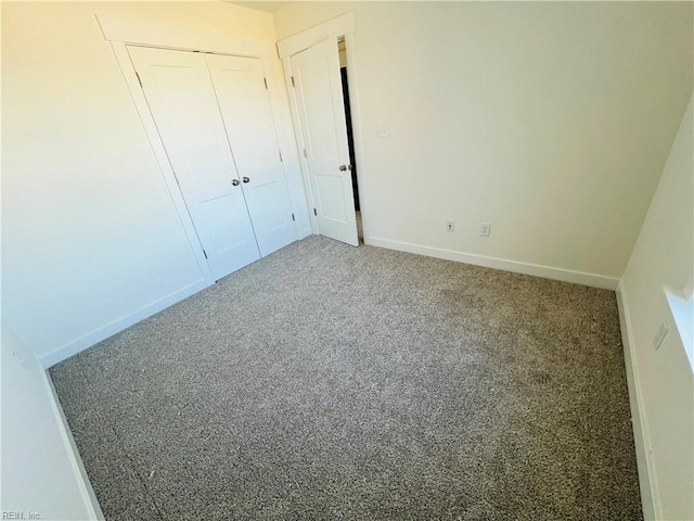 unfurnished bedroom featuring a closet and carpet