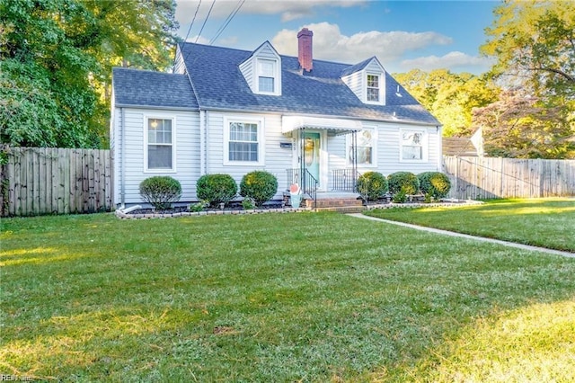 cape cod home featuring a front yard