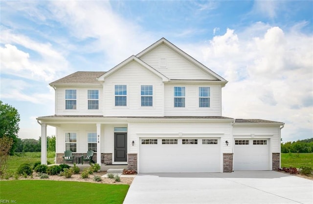 view of front of property featuring a garage, covered porch, and a front lawn