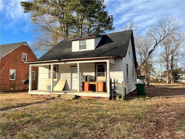 view of front of home with a porch and a front yard