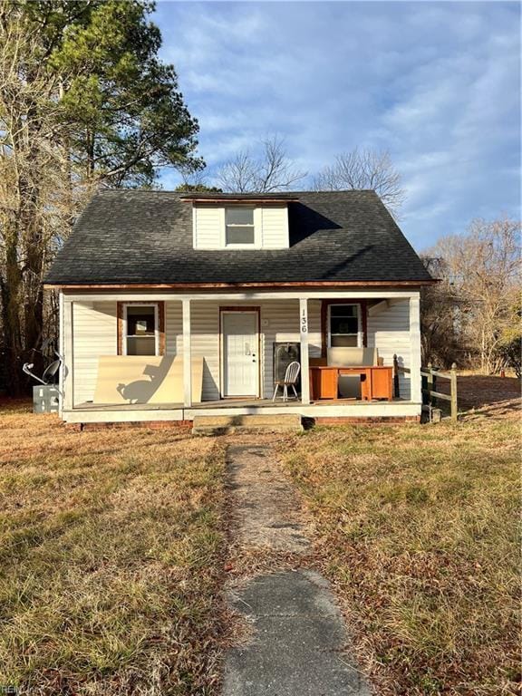 view of front of house featuring covered porch and a front lawn