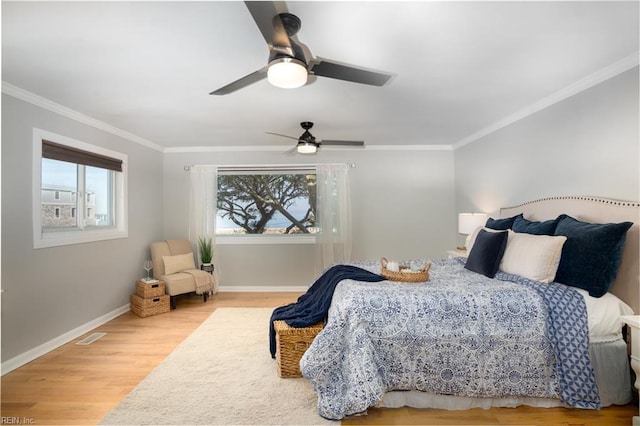 bedroom with crown molding, wood-type flooring, and ceiling fan