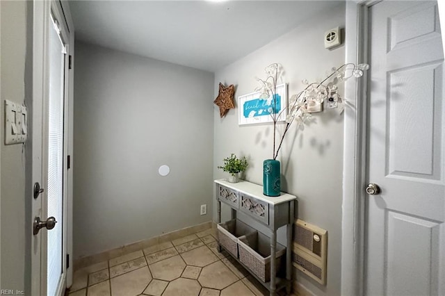 entryway featuring light tile patterned flooring and heating unit