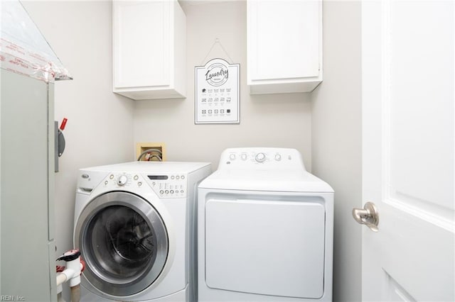 laundry area with cabinets and separate washer and dryer