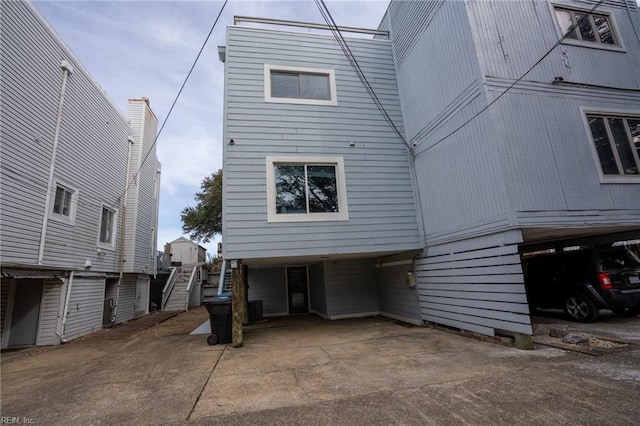 rear view of property with a carport