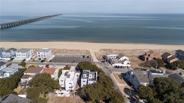 birds eye view of property with a water view and a beach view