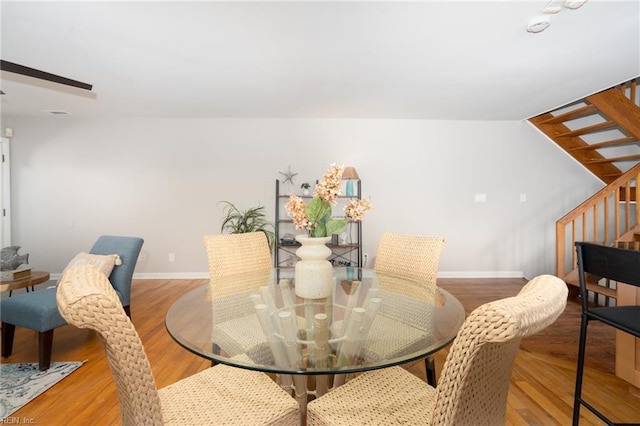 dining space with hardwood / wood-style floors