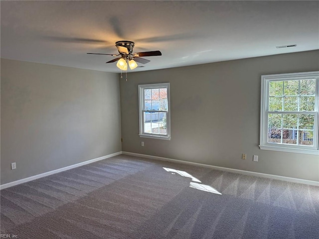 empty room with ceiling fan and carpet