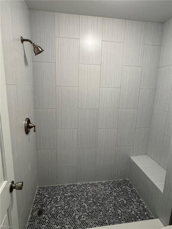 bathroom with tiled shower