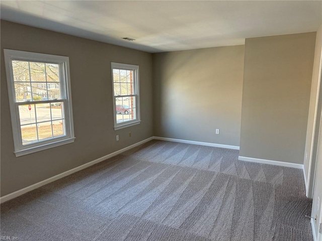 spare room featuring carpet floors and a healthy amount of sunlight