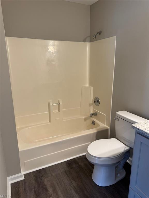 full bathroom featuring hardwood / wood-style flooring, vanity, toilet, and bathtub / shower combination