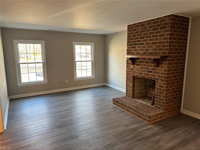 unfurnished living room with a fireplace and dark hardwood / wood-style flooring