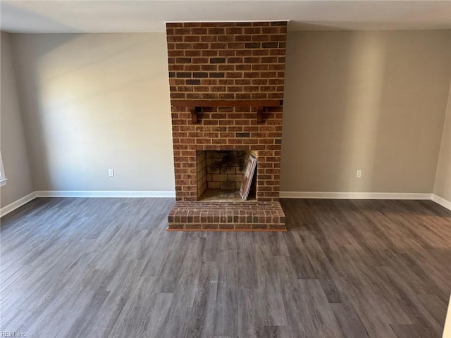 unfurnished living room with dark hardwood / wood-style floors and a fireplace