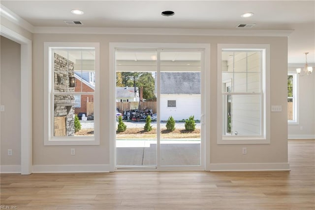 entryway with an inviting chandelier and light hardwood / wood-style floors