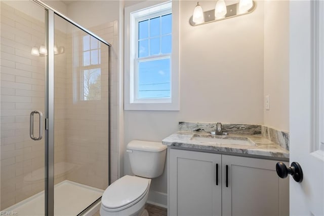 bathroom featuring vanity, toilet, and walk in shower