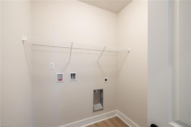 clothes washing area with hookup for a washing machine, hookup for an electric dryer, and hardwood / wood-style flooring