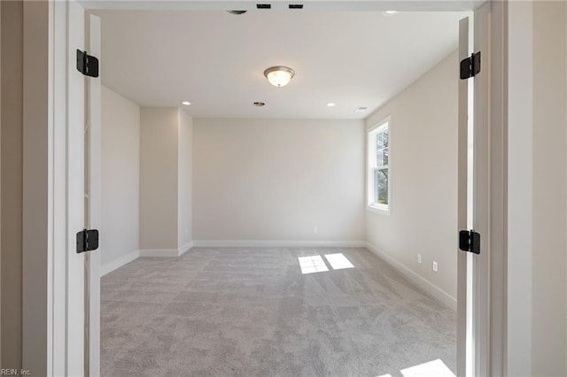 empty room featuring light colored carpet