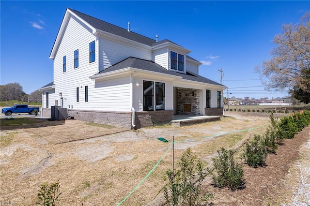 rear view of property with a patio and central air condition unit