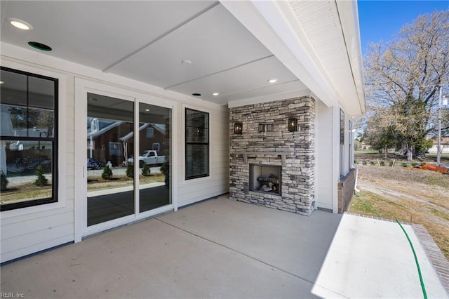 view of patio featuring an outdoor stone fireplace