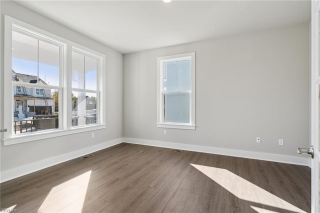 empty room featuring dark wood-type flooring