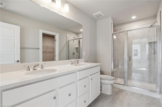 bathroom with vanity, an enclosed shower, and toilet