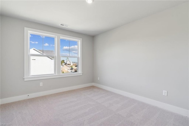 unfurnished room with light colored carpet