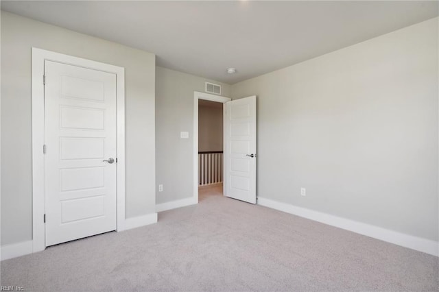 unfurnished bedroom featuring light carpet