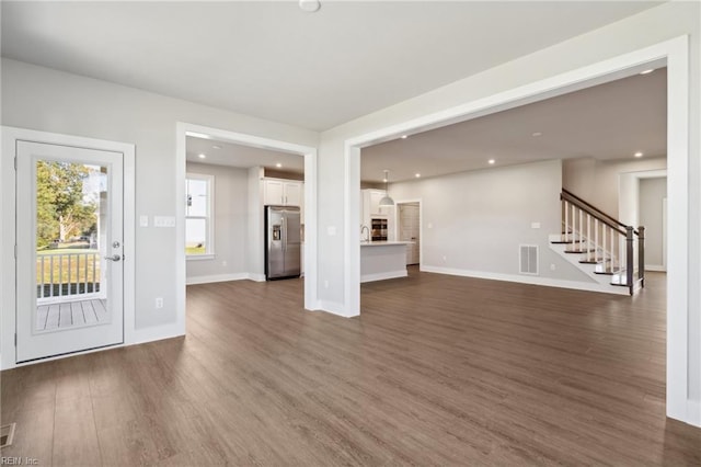 unfurnished living room featuring dark wood-type flooring