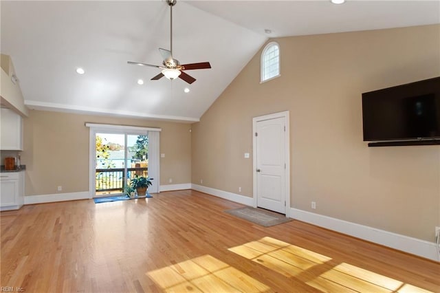 unfurnished living room with ceiling fan, high vaulted ceiling, and light hardwood / wood-style flooring