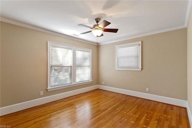 empty room with light hardwood / wood-style flooring, ornamental molding, and ceiling fan