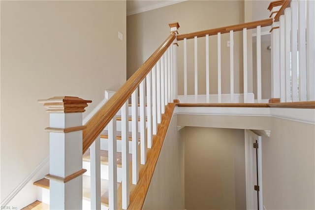 stairway featuring crown molding