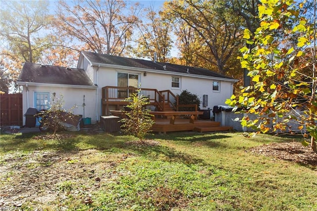 back of house featuring a yard and a deck