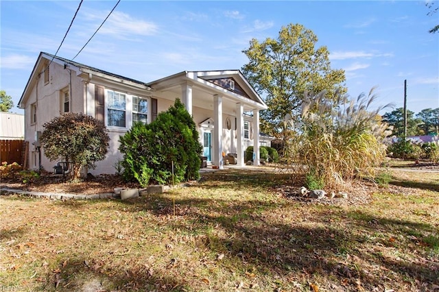 view of side of property with a lawn