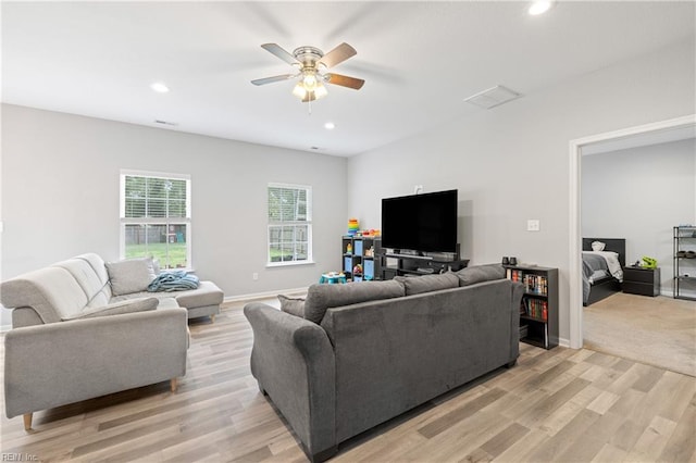 living room featuring ceiling fan and light wood-type flooring