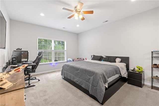 bedroom featuring ceiling fan and light carpet