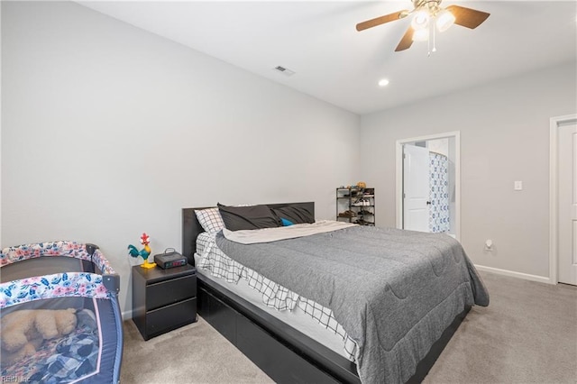 bedroom with ceiling fan and light carpet