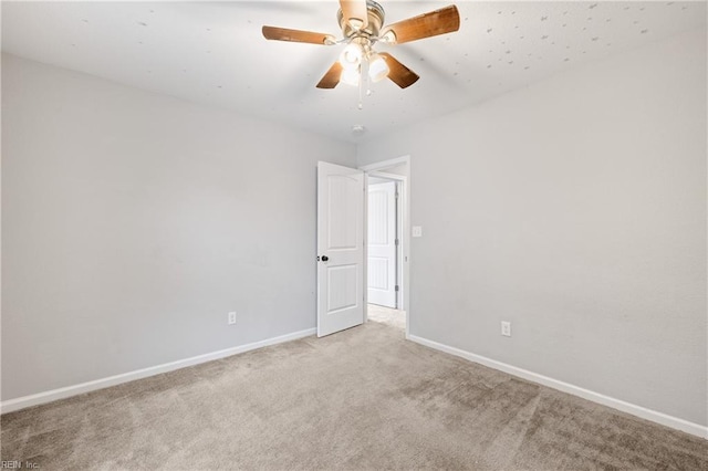 empty room featuring light colored carpet and ceiling fan