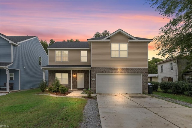 view of front property with a yard and a garage