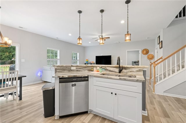 kitchen featuring sink, light stone counters, light wood-type flooring, dishwasher, and white cabinets