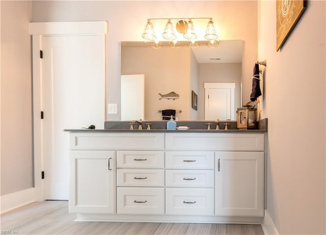 bathroom with hardwood / wood-style flooring and vanity