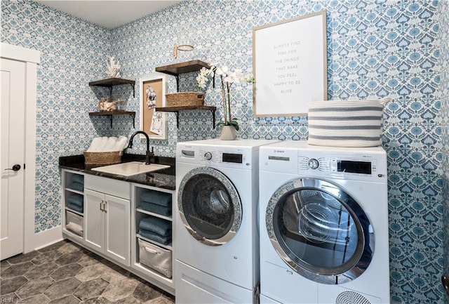 clothes washing area with cabinets, separate washer and dryer, and sink