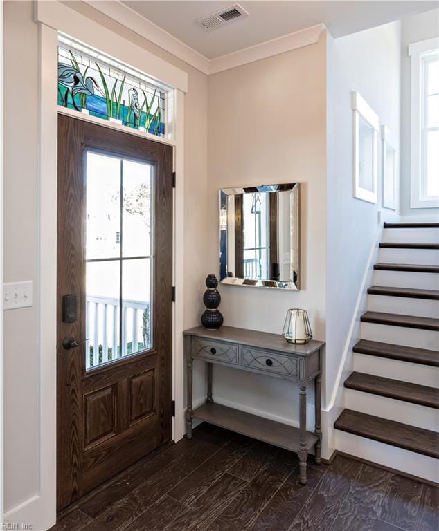 entrance foyer featuring dark hardwood / wood-style flooring and crown molding