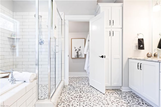 bathroom featuring vanity and shower with separate bathtub