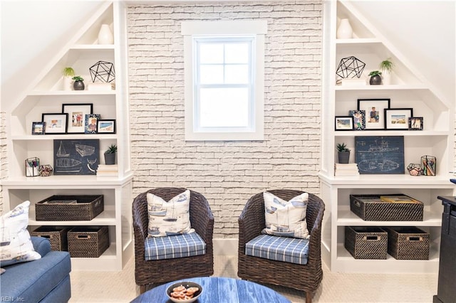 sitting room with brick wall and built in features