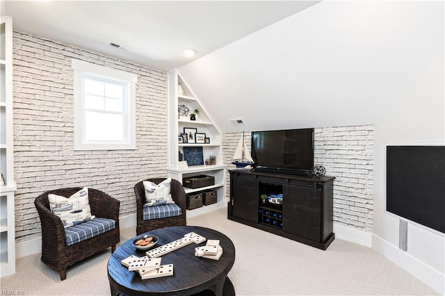 living room with light carpet, built in shelves, and lofted ceiling