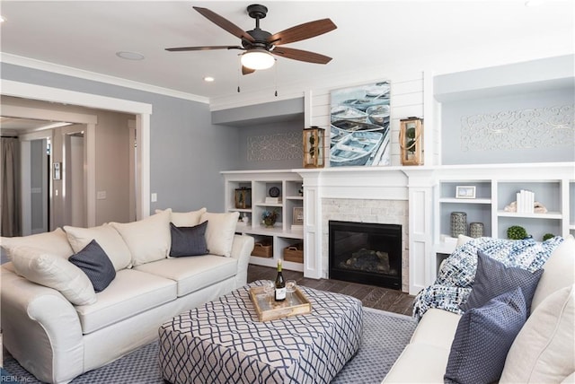 living room with ceiling fan, ornamental molding, and hardwood / wood-style floors