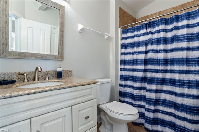 bathroom with vanity, a shower with curtain, lofted ceiling, and toilet