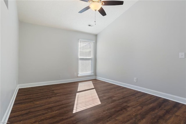 spare room featuring lofted ceiling, dark hardwood / wood-style floors, and ceiling fan