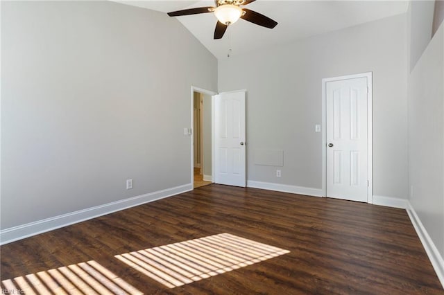 unfurnished bedroom featuring dark wood-type flooring, ceiling fan, and high vaulted ceiling